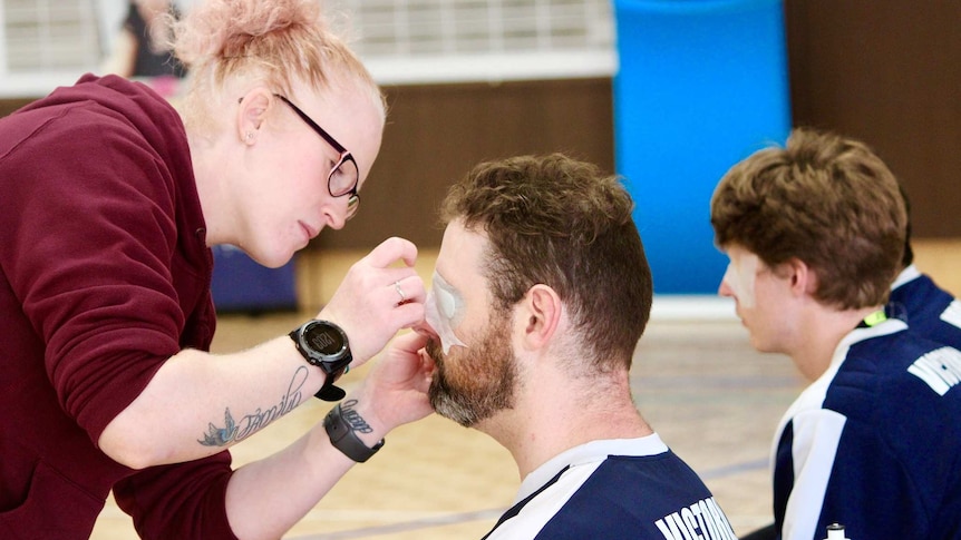 Goalball players have their eyes taped.