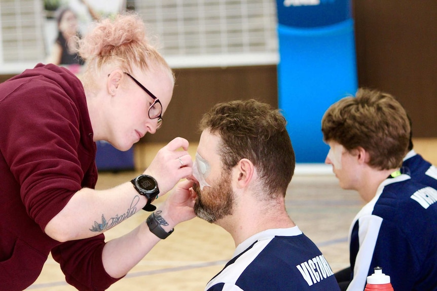 Goalball players have their eyes taped.
