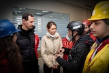 Bashar al Assad and Asma Assad listen to emergency workers talk 