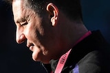 A profile shot of Ross Lyon looking down