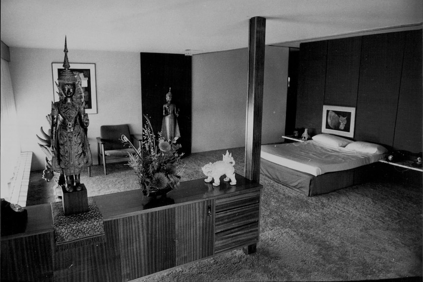 A mid-century modern bedroom with Khmer and Thai sculptures