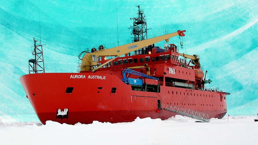 A large red vessel with scientific instruments all over it amidst a snow covered ice shelf.