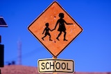 A school crossing sign in Roebourne which is slightly bent out of shape.