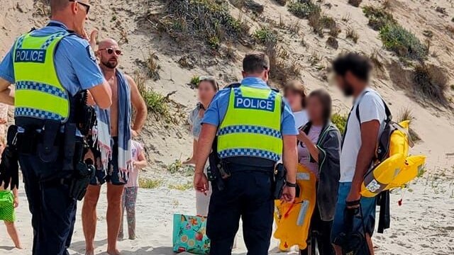 police with public on a beach