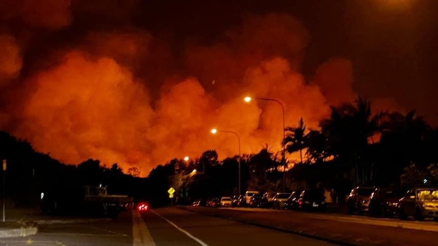 Large plumes of smoke and fire, orange coloured in night sky