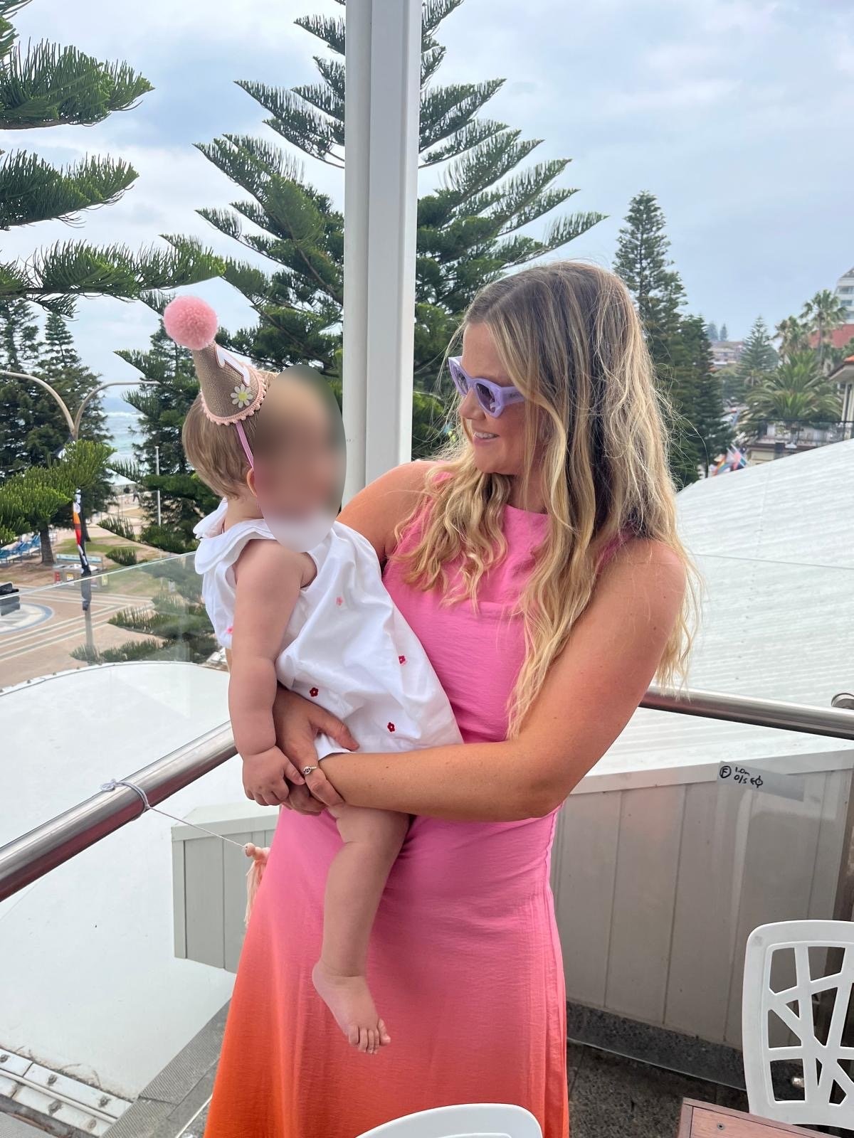 Sydney mother and Coogee local, Leah Stewart, who was mauled by a shark holds a baby 