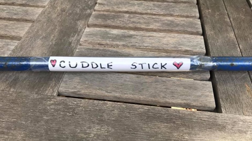 Stick with 'cuddle stick' label on it