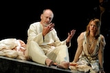 John Bell as King Lear looks anguished, seated beside his daughter Cordelia, anxiously listening to him speak