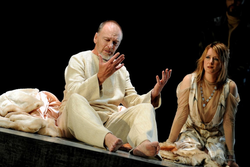 John Bell as King Lear looks anguished, seated beside his daughter Cordelia, anxiously listening to him speak