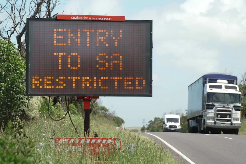 Sign on highway says "entry to SA restricted".