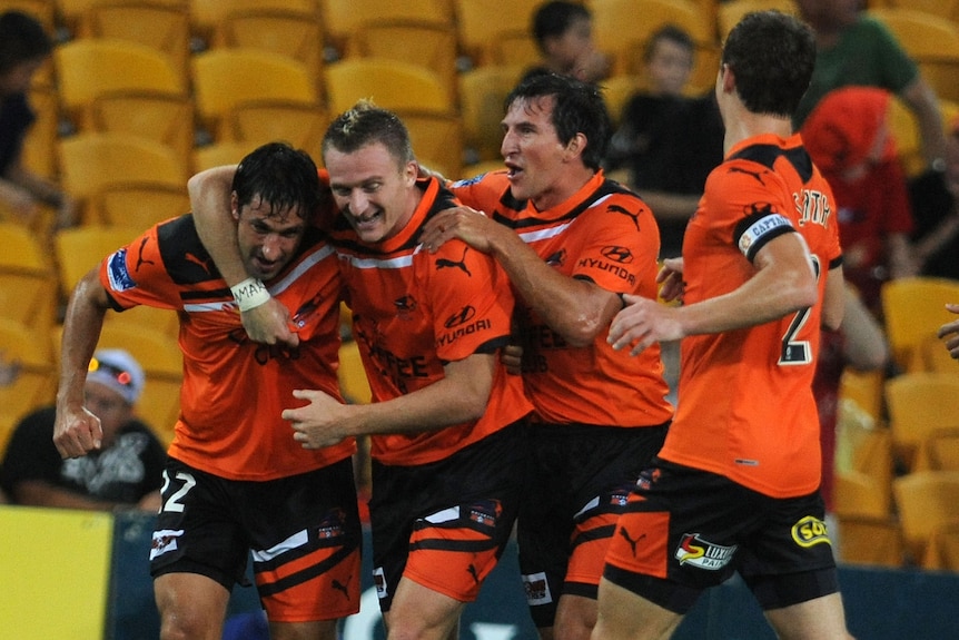 Etched in history: Roar players celebrate one of Besart Berisha's two goals.