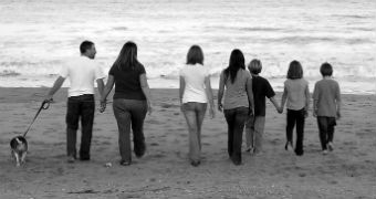 Photo of family walking along the beach with dog