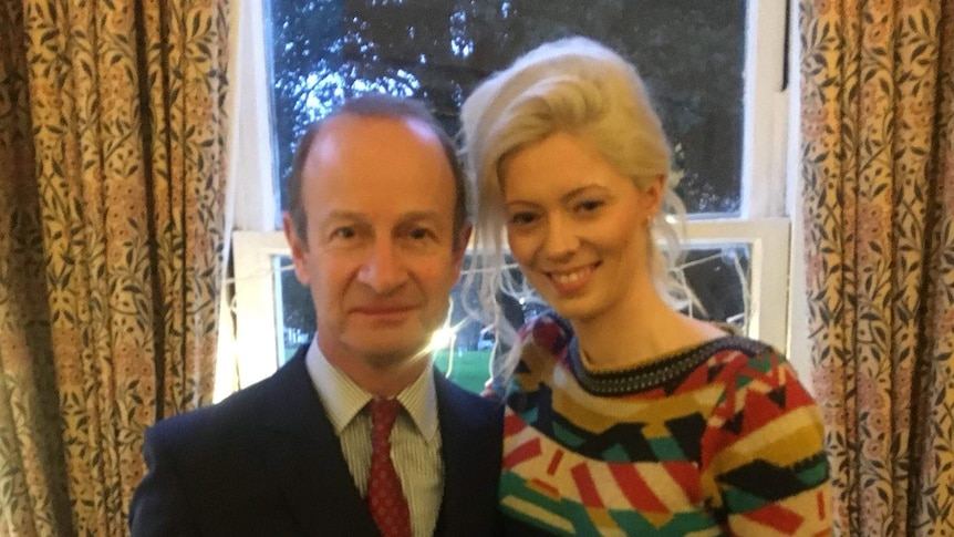 Henry Bolton, left, wearing a suit, stands beside girlfriend Jo Marney