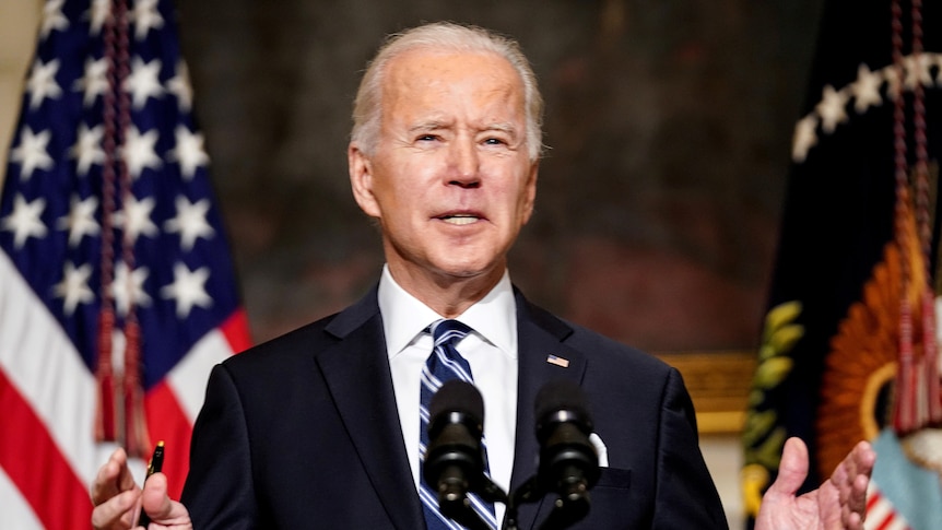 Joe Biden speaks behind a podium