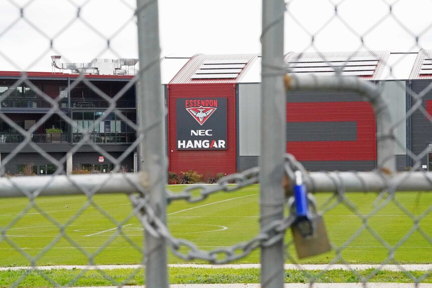 A view of the front of Essendon's training base through a padlocked gate