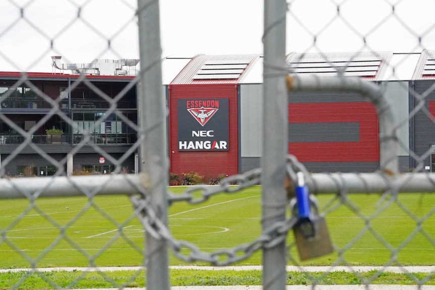 A view of the front of Essendon's training base through a padlocked gate