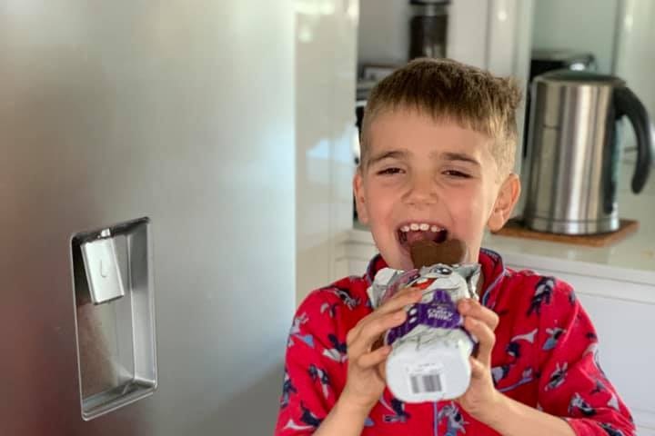 Isaac Allen eating a dairy milk easter bunny chocolate