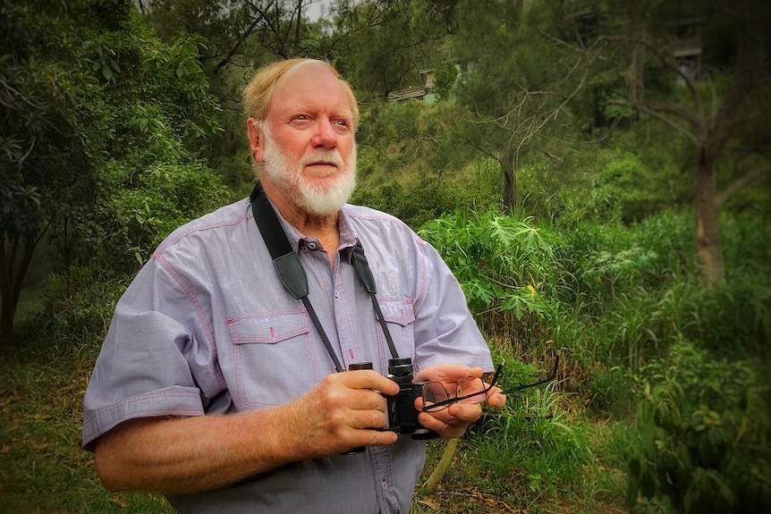 Peter Ogilvie, a retired conservationist in his yard