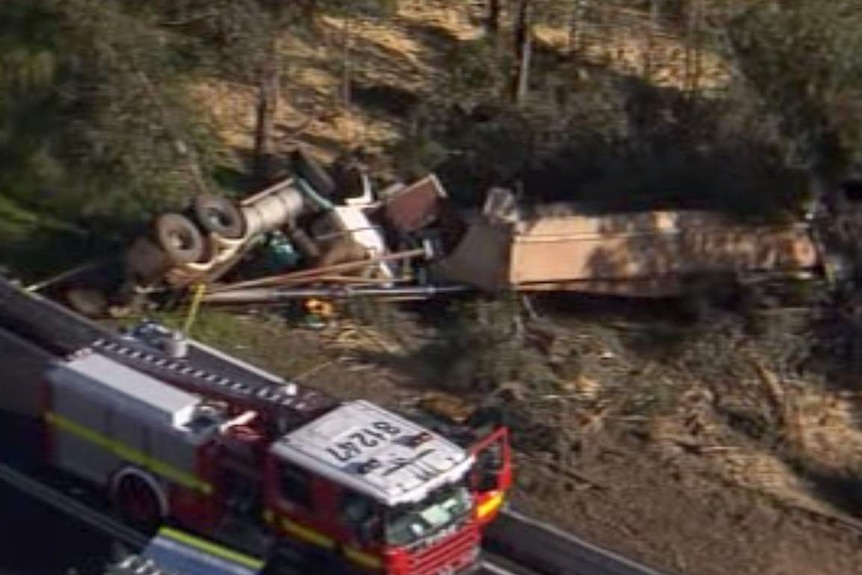 The overturned truck and trailer after the crash near Dwellingup