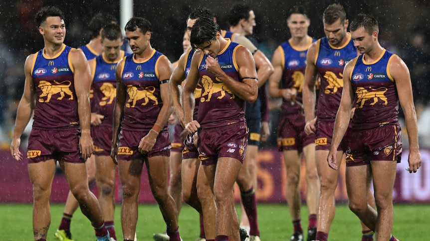 Brisbane Lions AFL players look despondent after loss to Geelong.