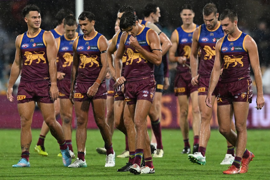 Brisbane Lions AFL players look despondent after loss to Geelong.