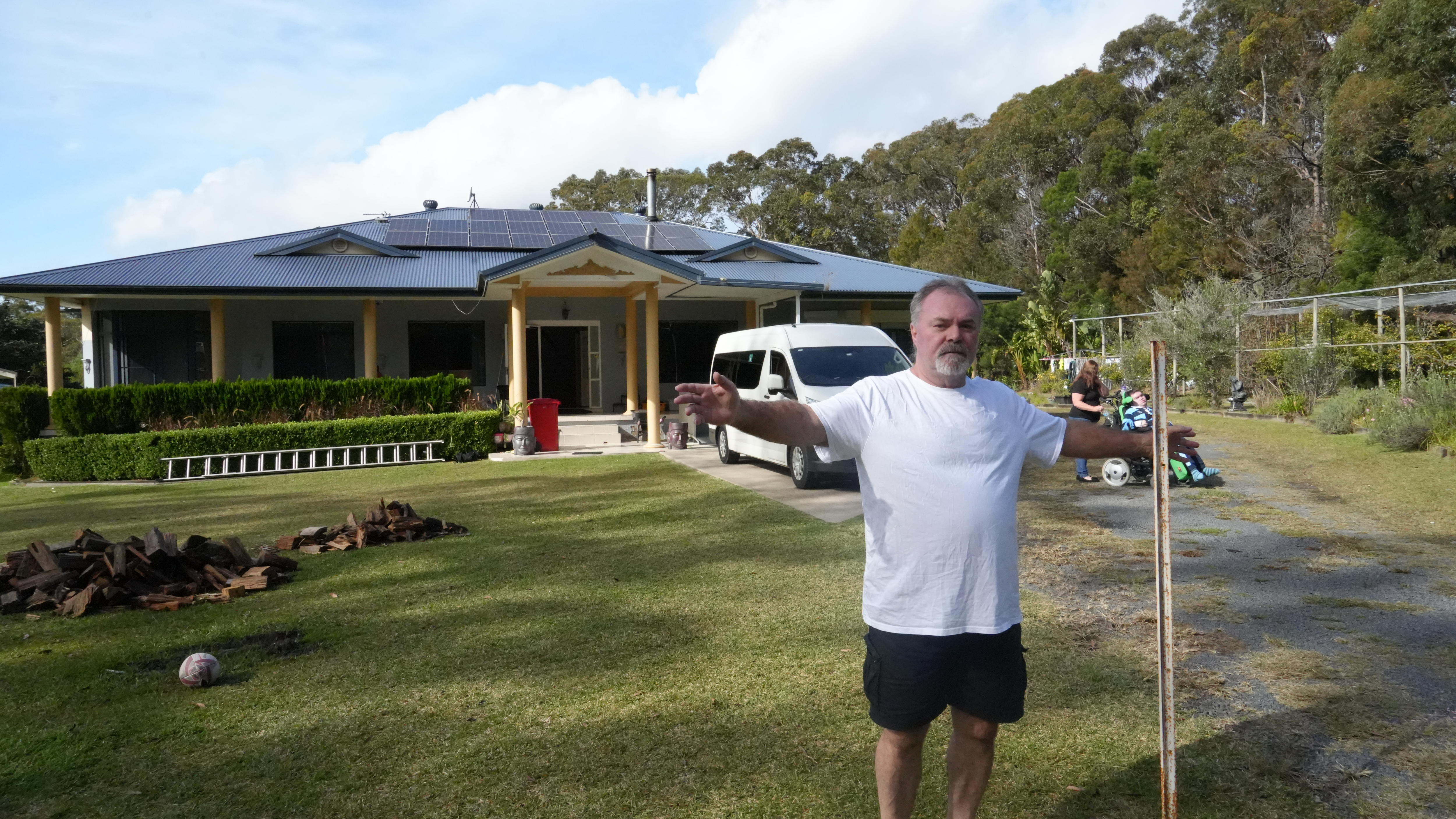 Man standing with arms pointing out.