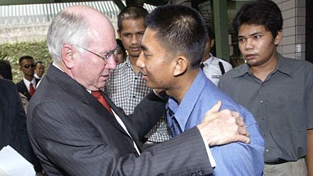 John Howard greets a member of the Australian embassy security detail who was injured in the September attack on the Australian embassy.