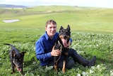Daniel Lutz on his farm in Henty with two of his kelpies.