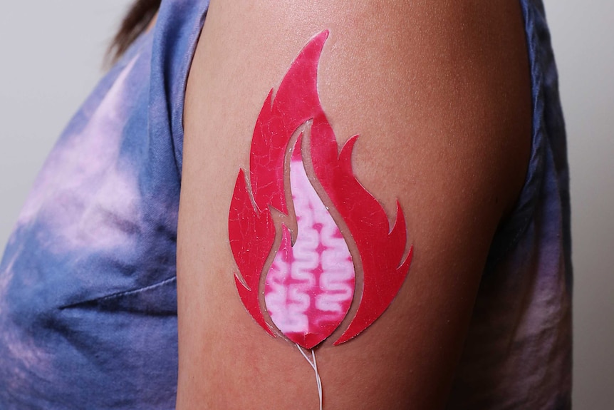 A tattoo in the shape of a flame.