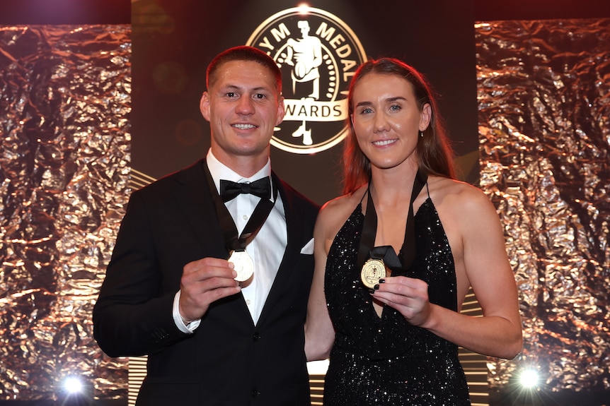 NRL and NRLW Dally M Medal winners Kalyn Ponga and Tamika Upton pose with their awards in formal wear.