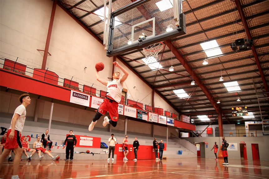 A basketball player leaps up to dunk a ball at training at the Snakepit.