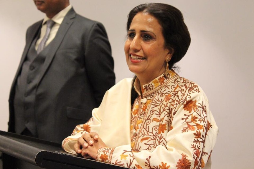 Naela Choan speaks from a lectern at a diplomatic event