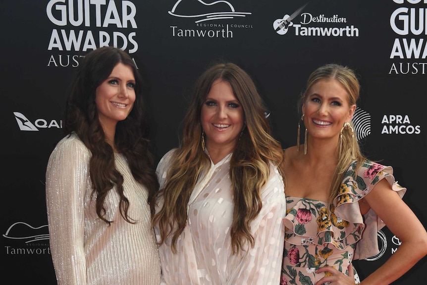 The McClymonts smile as they stand together on the red carpet at Golden Guitar Awards