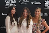 The McClymonts smile as they stand together on the red carpet at Golden Guitar Awards