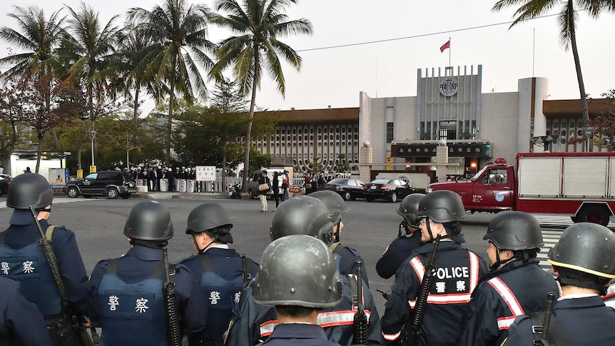Police officers stand guard outside Taiwan's Kaohsiung prison.