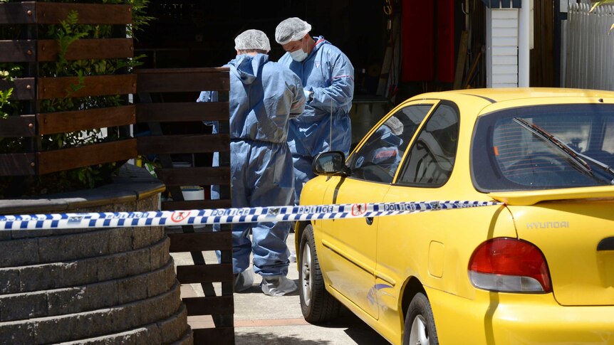 Forensics officers inspect a house at Clayfield in Brisbane's inner north on October 4, 2012.