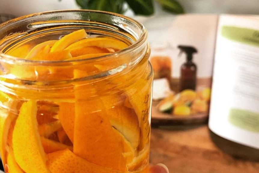 Orange peel inside a glass jar with vinegar