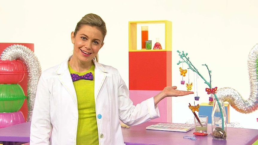 Rachael on the Play School Science Time set wearing a lab coat with craft butterflies