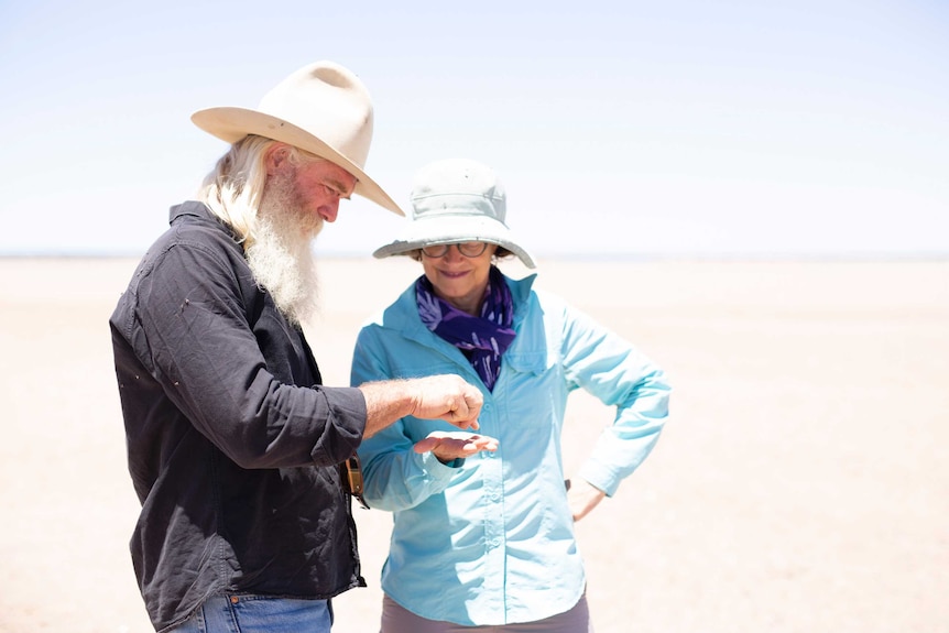 Greg Quicke and Carolyn Oldham standing on salt lake