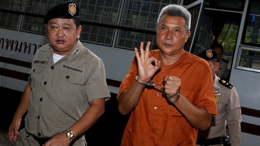 Tom Dundee, a Thai singer accused of insulting Thailand's king, gestures as he arrives at a Bangkok court on June 1 2016.