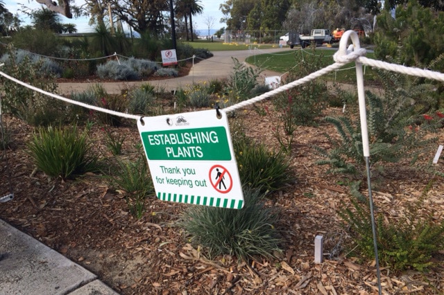 A sign advises people to keep out of the gardens at Kings Park.