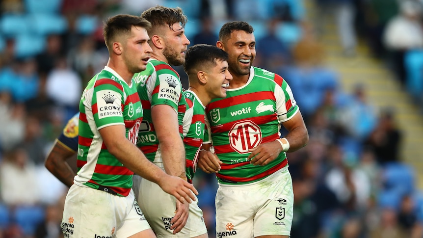 South Sydney Rabbitohs teammates embrace Alex Johnston after and NRL try.