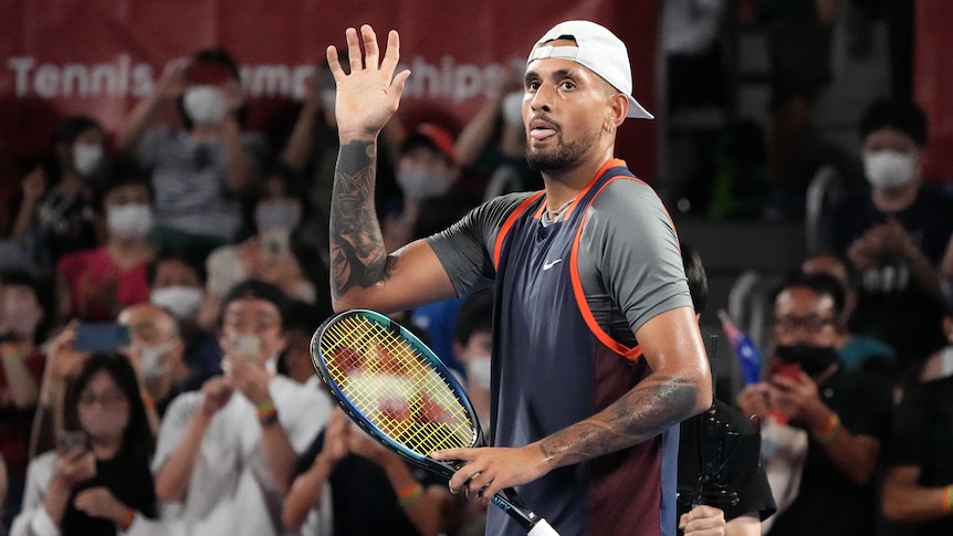 Nick Kyrgios clenches his fist as he waves to the crowd after a tennis match at the Japan Open.