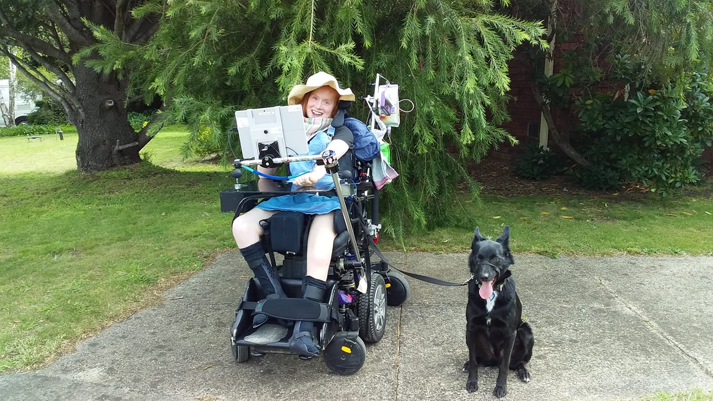 Kiah in her wheelchair with her communication system.