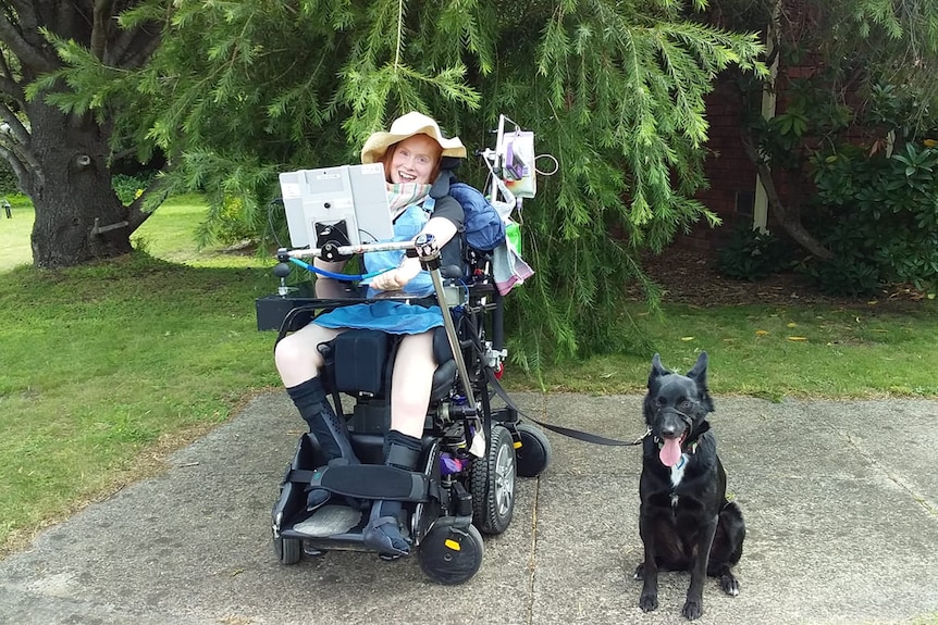 Kiah in her wheelchair with her communication system.