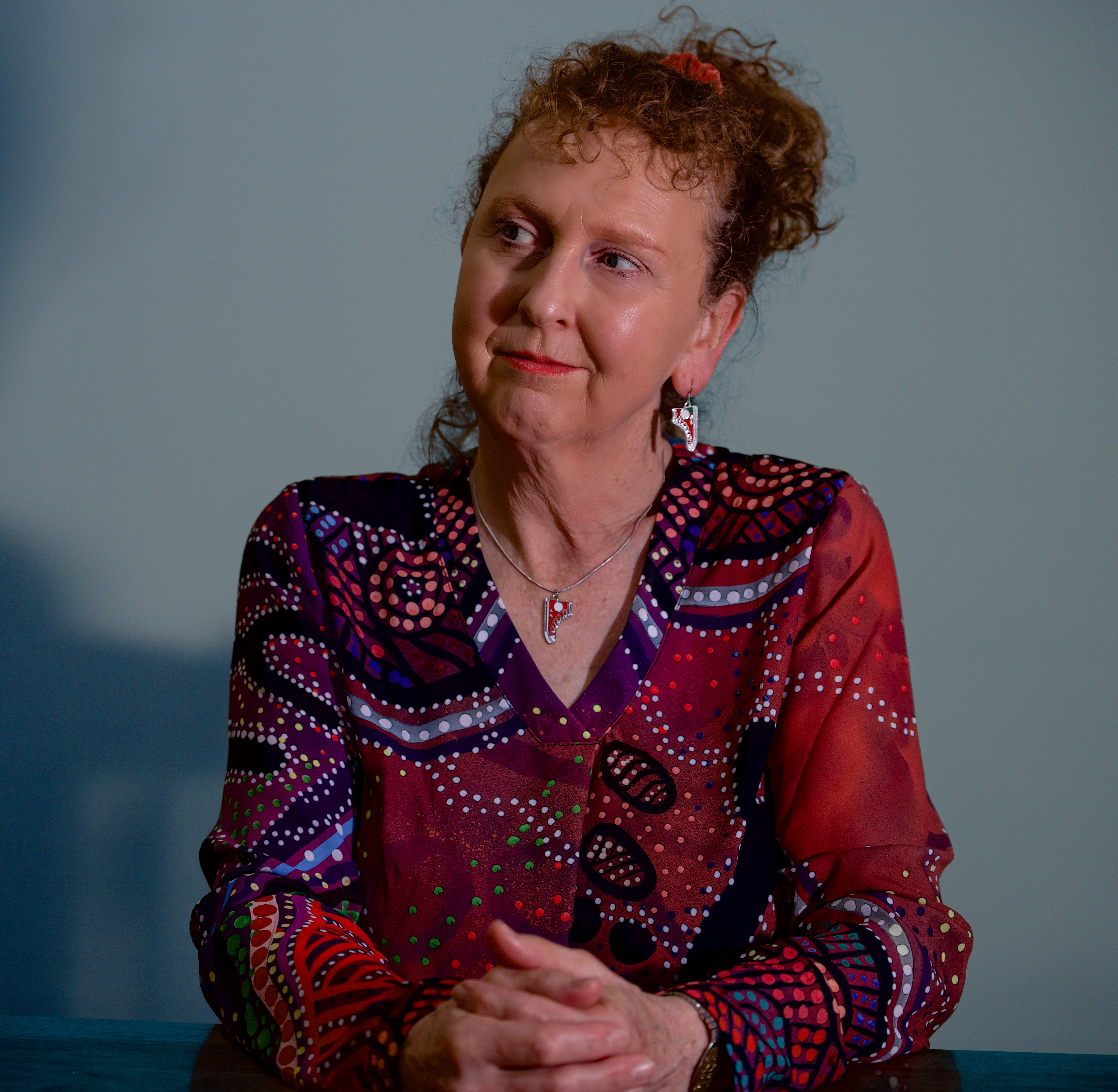 A close up photo of a woman looking to the side.