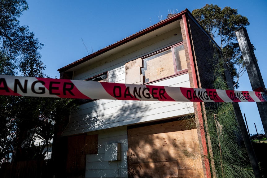 A public housing property in Claymore, roped off with tape that reads 'danger'.