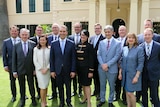 Steven Marshall and his new Cabinet smile for a group photo on the lawns of Government House.