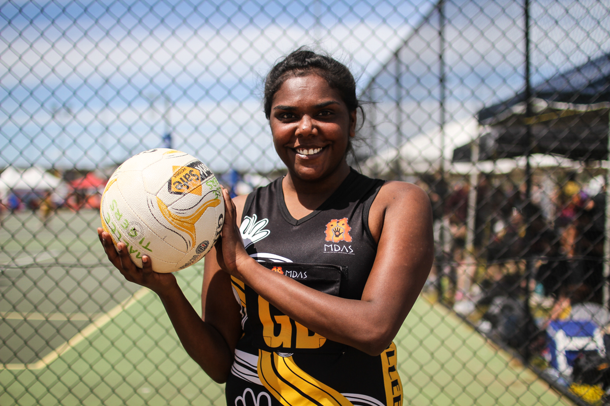 Nikita Williams, 21, Mallee Tigers from Mildura holding a netball and smiling.