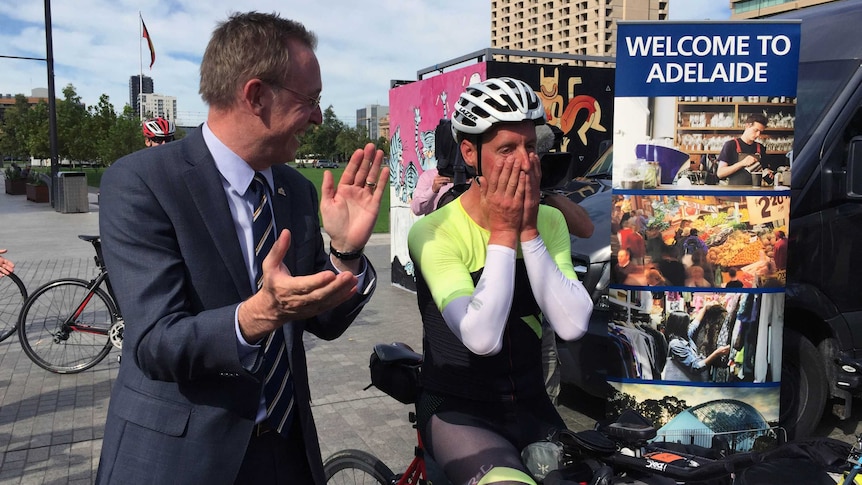 Martin Haese claps as cyclist Kristof Allegaert takes a breather.